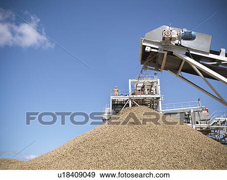 Stones pouring in pile from conveyor View Large Photo Image Stock Photo - Stones pouring in pile from conveyor. Fotosearch