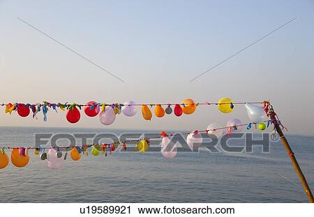 String of balloons floating in wind View Large Photo Image Stock Image - String of balloons floating in wind. Fotosearch