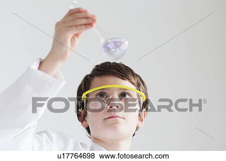 Student examining beaker of liquid View Large Photo Image Stock Photo - Student examining beaker of liquid. Fotosearch