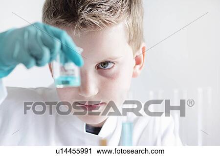 Student examining liquid in beaker View Large Photo Image Stock Image - Student examining liquid in beaker. Fotosearch