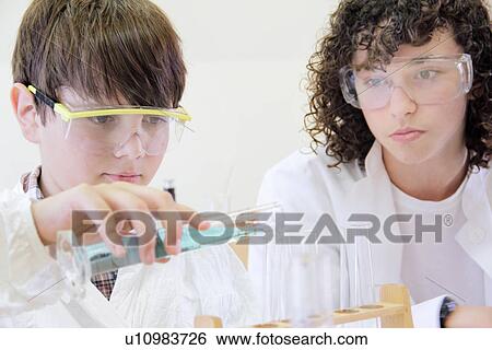 Student pouring liquid into test tubes View Large Photo Image Stock Photograph - Student pouring liquid into test tubes. Fotosearch