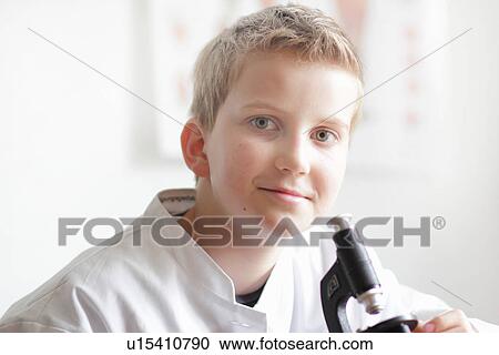 Student smiling at microscope View Large Photo Image Stock Image - Student smiling at microscope. Fotosearch