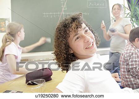 Student smiling in class View Large Photo Image Stock Image - Student smiling in class. Fotosearch