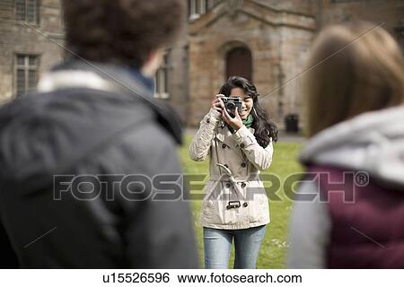Stock Photograph - Student taking picture of friends. Fotosearch