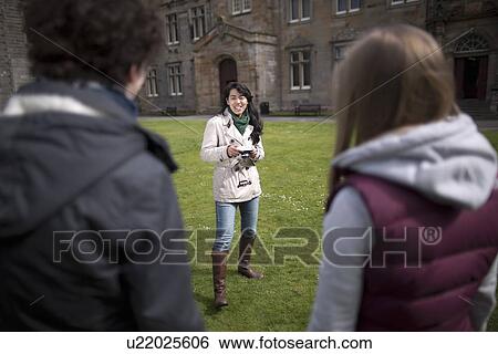 Stock Photograph - Student taking picture of friends. Fotosearch