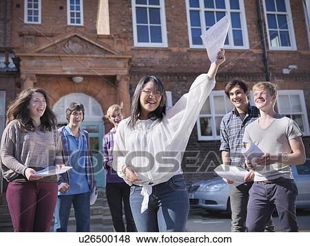 Stock Photo - Students reading grades together. Fotosearch
