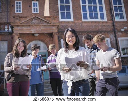 Stock Photography - Students reading grades together. Fotosearch