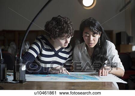 Stock Image - Students reading map in class. Fotosearch