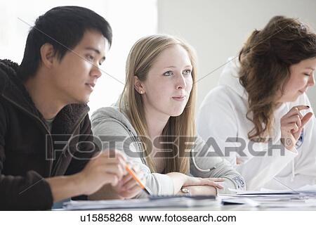 Stock Photo - Students sitting at desk in class. Fotosearch