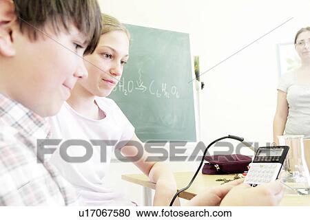 Stock Image - Students working in technology lab. Fotosearch
