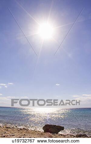 Sun shining over sandy beach View Large Photo Image Stock Photo - Sun shining over sandy beach. Fotosearch