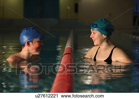 Swimmers talking in pool lanes View Large Photo Image Stock Image - Swimmers talking in pool lanes. Fotosearch