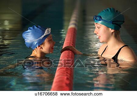 Swimmers talking in pool lanes View Large Photo Image Stock Photo - Swimmers talking in pool lanes. Fotosearch