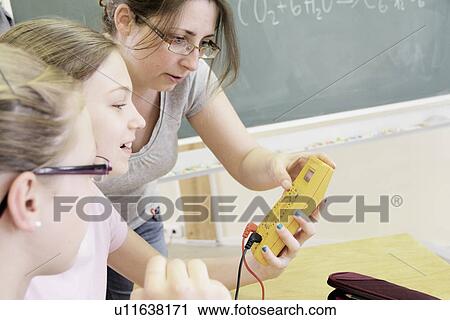 Stock Image - Teacher and students in technology lab. Fotosearch