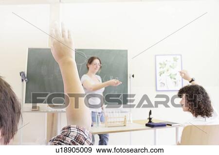 Stock Photo - Teacher calling on students in class. Fotosearch