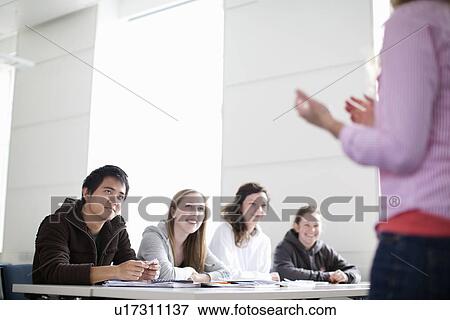 Teacher talking to students in class View Large Photo Image Stock Photo - Teacher talking to students in class. Fotosearch