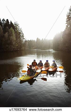 Picture - Teacher talking to students in kayaks. Fotosearch