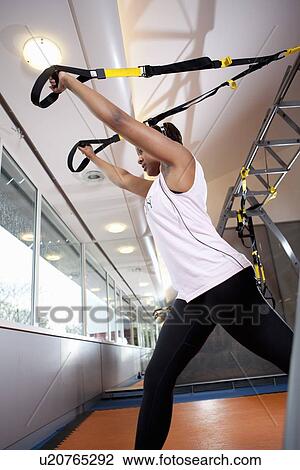 Teenage girl exercising in gym View Large Photo Image Stock Image - Teenage girl exercising in gym. Fotosearch