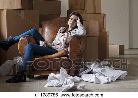 Stock Photograph - Teenage girl having coffee in new home. Fotosearch