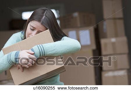 Teenage girl hugging cardboard box View Large Photo Image Stock Photography - Teenage girl hugging cardboard box. Fotosearch