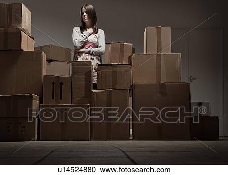 Teenage girl in pile of cardboard boxes View Large Photo Image Stock Image - Teenage girl in pile of cardboard boxes. Fotosearch