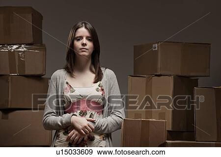 Teenage girl in pile of cardboard boxes View Large Photo Image Stock Photo - Teenage girl in pile of cardboard boxes. Fotosearch