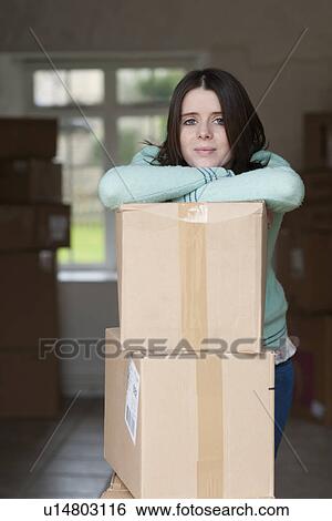 Teenage girl leaning on cardboard box View Large Photo Image Stock Photograph - Teenage girl leaning on cardboard box. Fotosearch