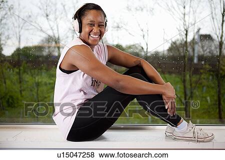 Teenage girl listening to headphones View Large Photo Image Stock Photo - Teenage girl listening to headphones. Fotosearch