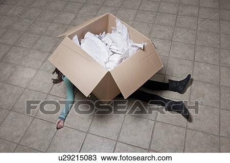 Teenage girl lying under cardboard box View Large Photo Image Stock Image - Teenage girl lying under cardboard box. Fotosearch