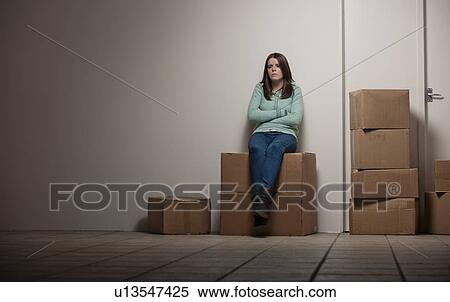 Teenage girl sitting on cardboard box View Large Photo Image Stock Photography - Teenage girl sitting on cardboard box. Fotosearch