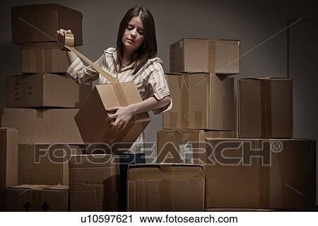 Teenage girl taping up cardboard boxes View Large Photo Image Stock Image - Teenage girl taping up cardboard boxes. Fotosearch