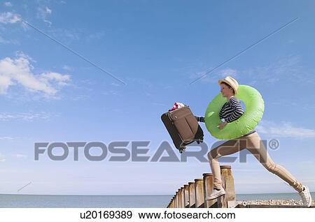 Teenage girl with suitcase on dock View Large Photo Image Stock Photo - Teenage girl with suitcase on dock. Fotosearch