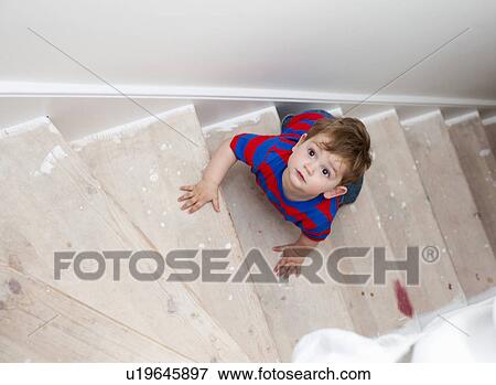 Toddler boy climbing steps View Large Photo Image Stock Photo - Toddler boy climbing steps. Fotosearch