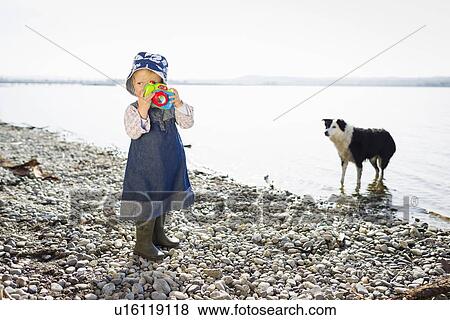Toddler girl playing with toy camera View Large Photo Image Stock Photo - Toddler girl playing with toy camera. Fotosearch