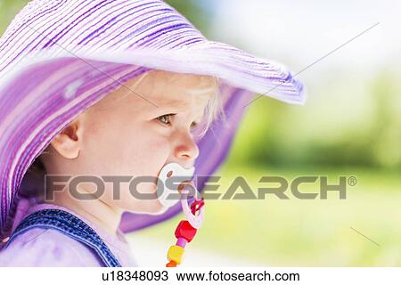 Toddler girl sucking pacifier outdoors View Large Photo Image Stock Image - Toddler girl sucking pacifier outdoors. Fotosearch