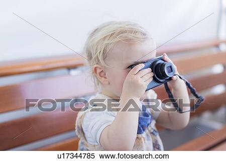 Toddler girl taking pictures with camera View Large Photo Image Stock Photography - Toddler girl taking pictures with camera. Fotosearch