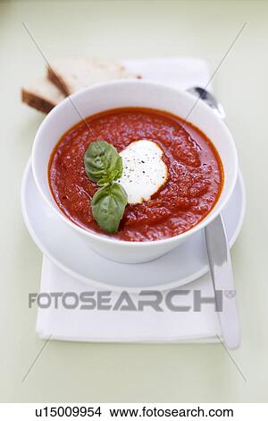 Picture - Tomato soup with creme fraiche, basil and bread. Fotosearch