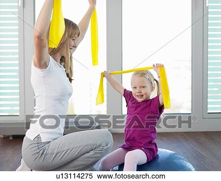 Trainer working with girl in gym View Large Photo Image Stock Photography - Trainer working with girl in gym. Fotosearch