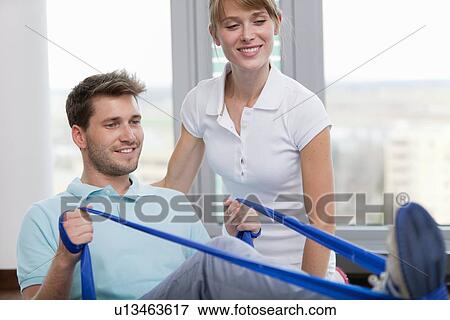 Trainer working with man in gym View Large Photo Image Stock Photo - Trainer working with man in gym. Fotosearch