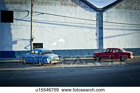 Vintage cars parked on city street View Large Photo Image Stock Photo - Vintage cars parked on city street. Fotosearch