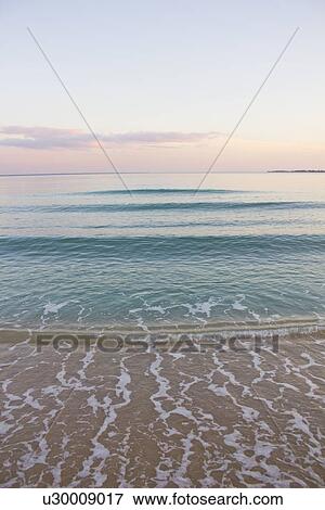 Waves washing up on sandy beach View Large Photo Image Stock Photo - Waves washing up on sandy beach. Fotosearch