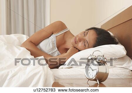 Stock Image - Woman asleep in bed. Fotosearch