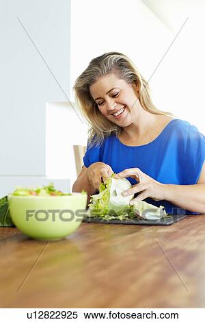 Woman chopping vegetables in kitchen View Large Photo Image Stock Photography - Woman chopping vegetables in kitchen. Fotosearch