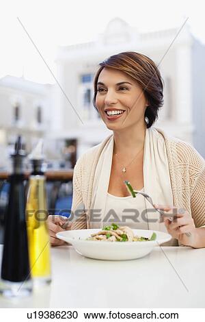 Woman eating at sidewalk cafe View Large Photo Image Stock Image - Woman eating at sidewalk cafe. Fotosearch