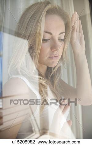 Woman gazing out window View Large Photo Image Stock Image - Woman gazing out window. Fotosearch