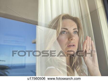 Woman gazing out window View Large Photo Image Stock Photograph - Woman gazing out window. Fotosearch