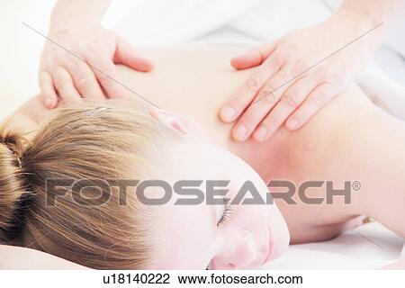 Stock Image - Woman having back massage in spa. Fotosearch