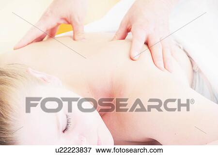 Stock Photo - Woman having back massage in spa. Fotosearch