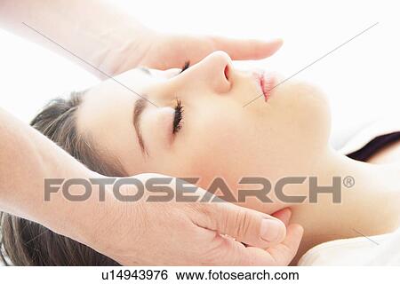 Stock Photograph - Woman having facial massage in spa. Fotosearch