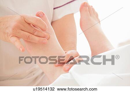 Woman having foot massage in spa View Large Photo Image Stock Image - Woman having foot massage in spa. Fotosearch